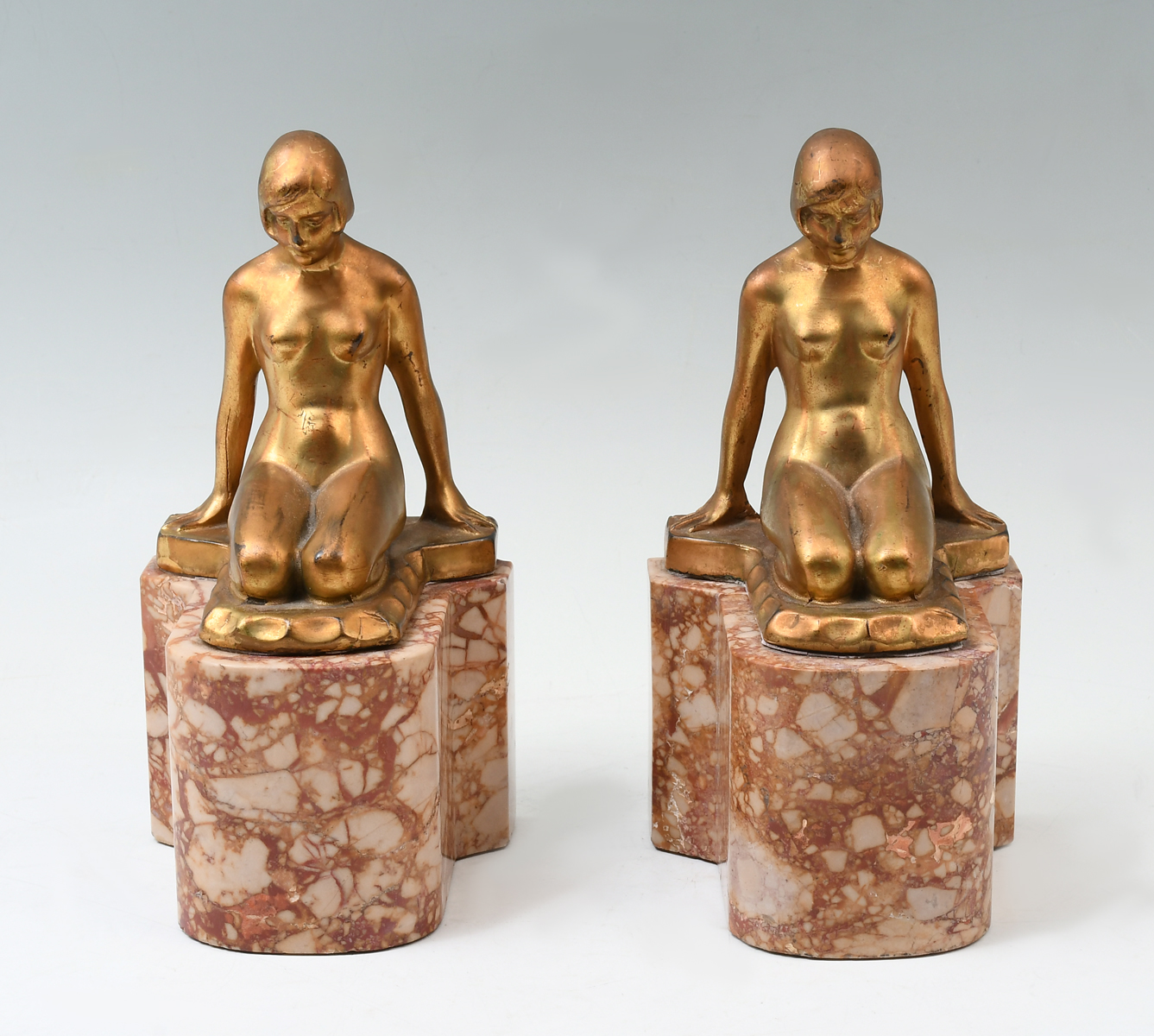 Appraisal: ART DECO NUDE BOOKENDS Pair of Gilt metal nude reclining