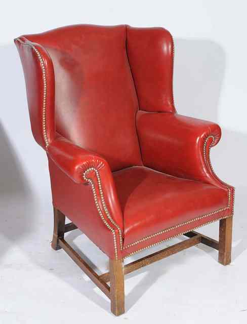 Appraisal: A GEORGIAN STYLE RED LEATHER UPHOLSTERED WING BACK ARMCHAIR wide