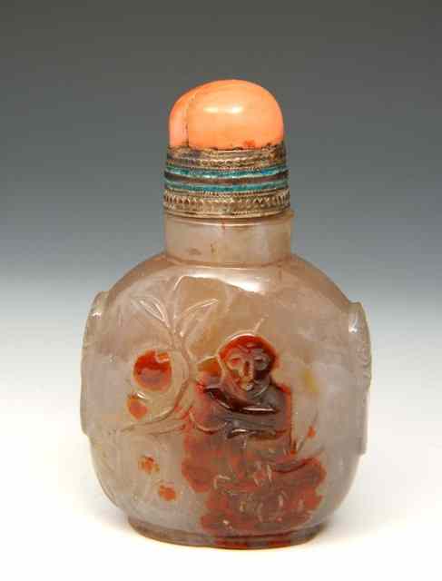 Appraisal: A CHINESE BLUE GREY CHALCEDONY SNUFF BOTTLE carved in relief