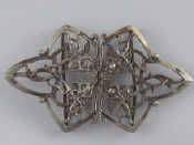 Appraisal: A silver nurse's belt buckle with angels bows hearts etc