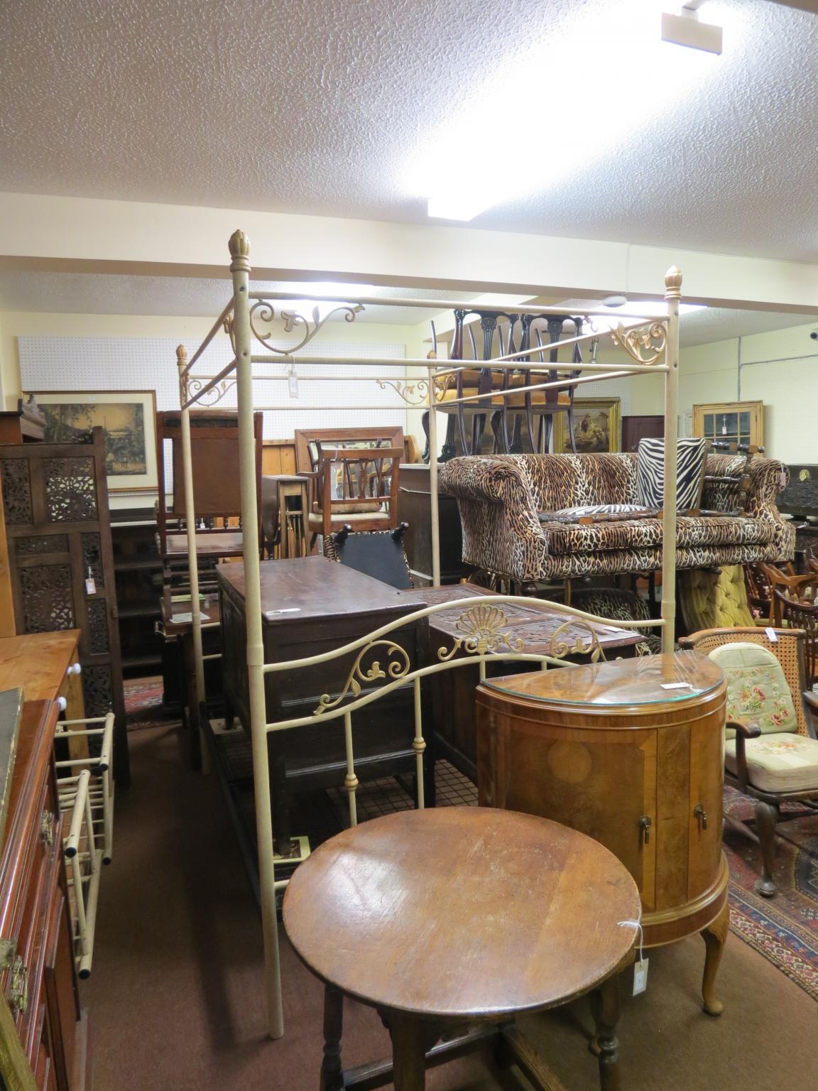 Appraisal: A cream-finished tubular metal four-poster bedstead with ornamental head and