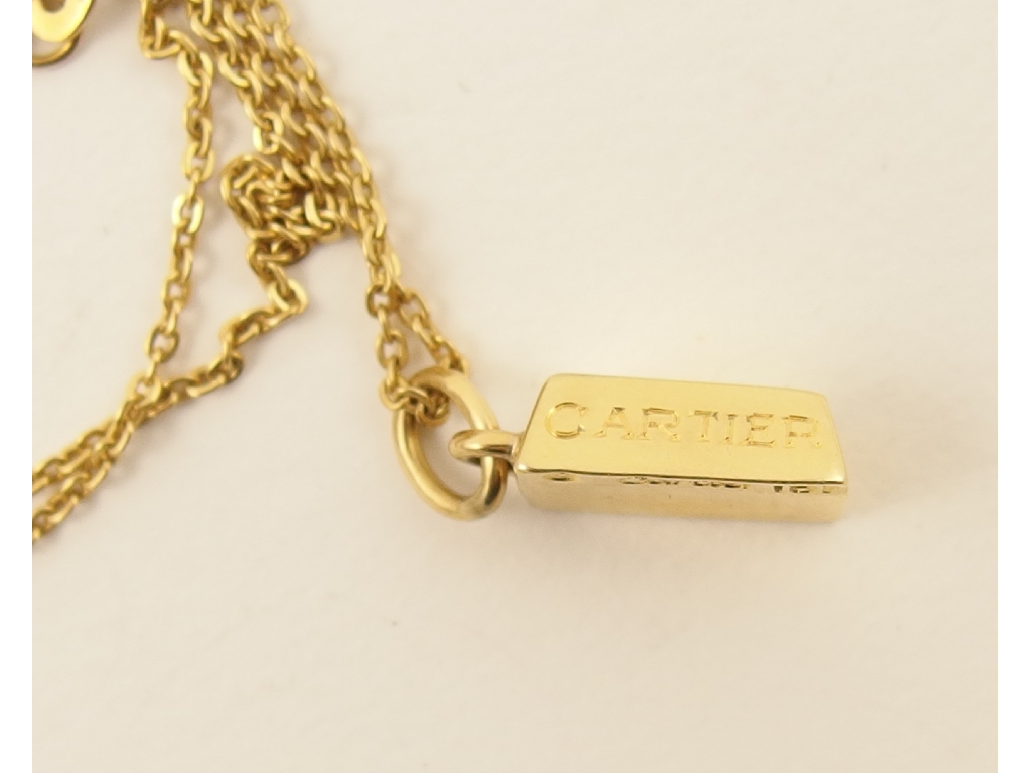 Appraisal: An ct Cartier gold ingot pendant with hand engraved Cartier