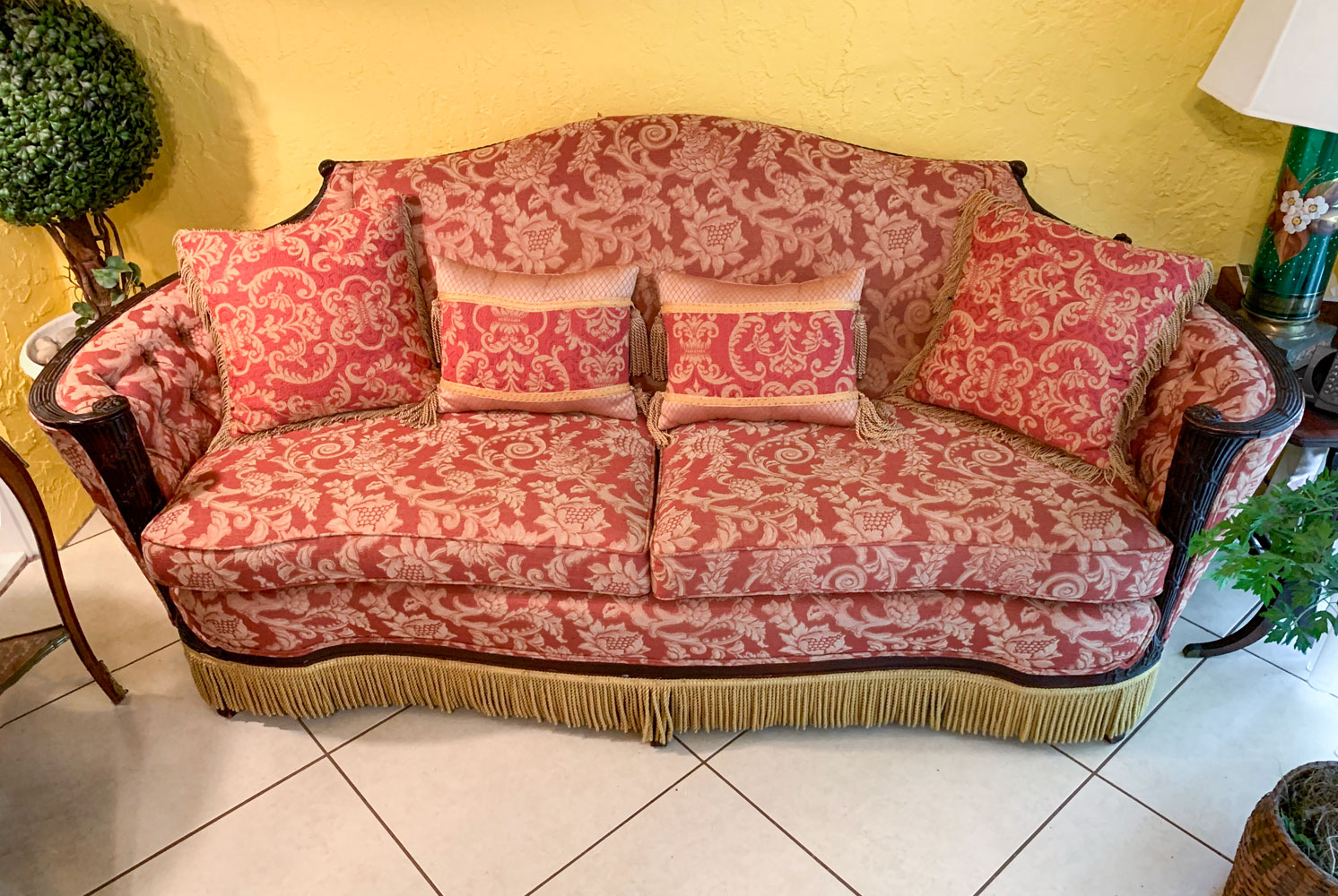 Appraisal: CARVED FRINGED SOFA Victorian sofa having a carved scrolling foliate