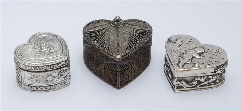 Appraisal: THREE SILVER HEART-SHAPED BOXES One impressed 'Germany' with hinged putto