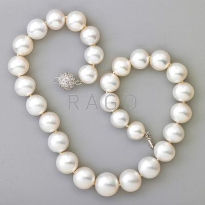 Appraisal: WHITE SOUTH SEA PEARL AND DIAMOND NECKLACE spherical pearls -