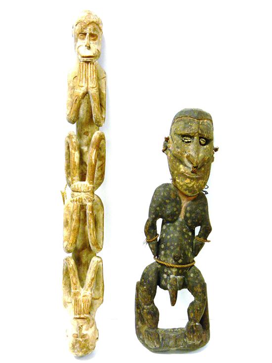 Appraisal: Two New Guinea wooden statues including one carved and pierced