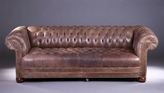 Appraisal: LIGHT BROWN DISTRESSED LEATHER CHESTERFIELD SOFA th century with brass