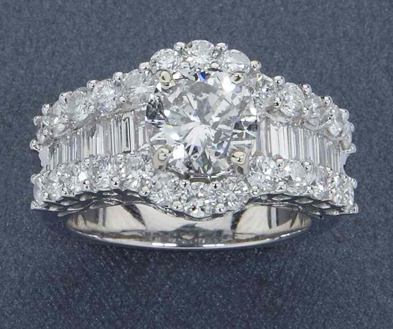 Appraisal: K gold and diamond wedding ringhaving a central oval brilliant