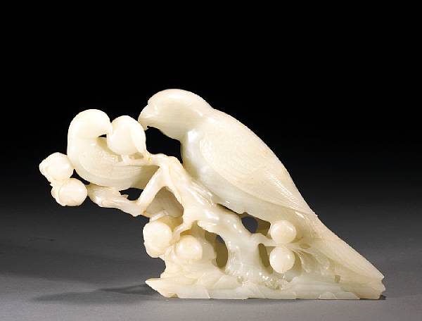 Appraisal: A white jade carving of parrots on a peach branch