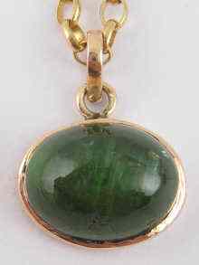 Appraisal: A carat gold cabochon tourmaline pendant and chain tourmaline approx