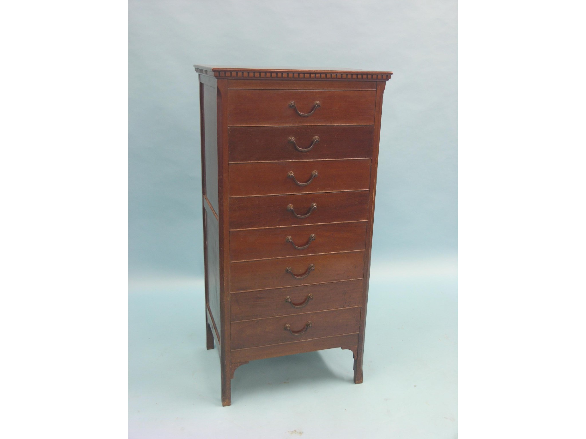 Appraisal: An early th century mahogany music chest eight fall-front drawers