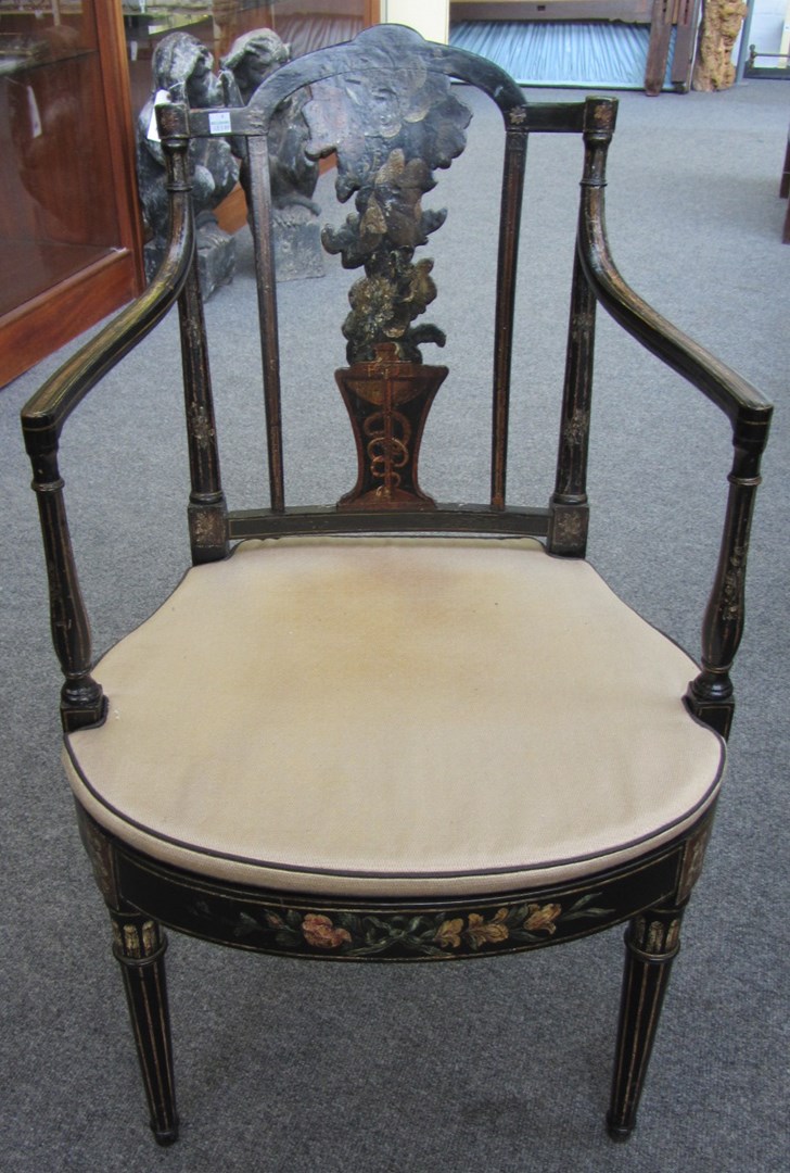 Appraisal: An early th century floral painted ebonised open armchair with