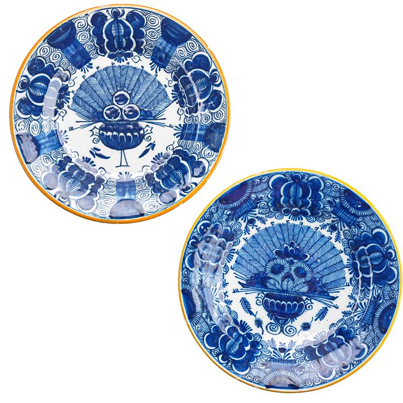 Appraisal: DELFT PAINTED PLATES Two Each decorated with floral bouquets early