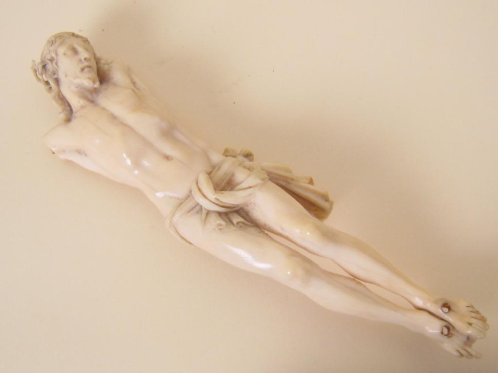 Appraisal: A carved ivory figure of crucified Christ lacks arms in