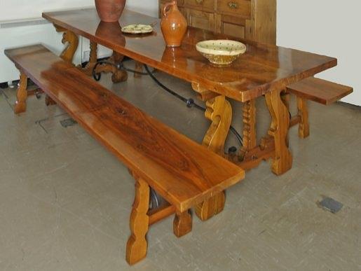 Appraisal: A modern Spanish walnut dining table with open trestle ends