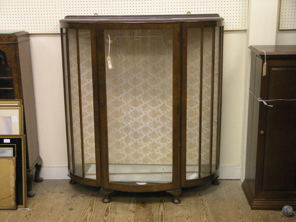 Appraisal: A bow fronted walnut veneered display cabinet single glass door