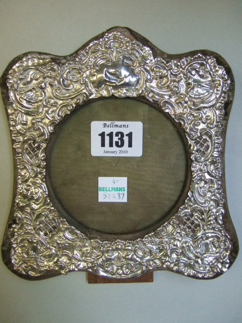 Appraisal: A silver mounted shaped square photograph frame with embossed and