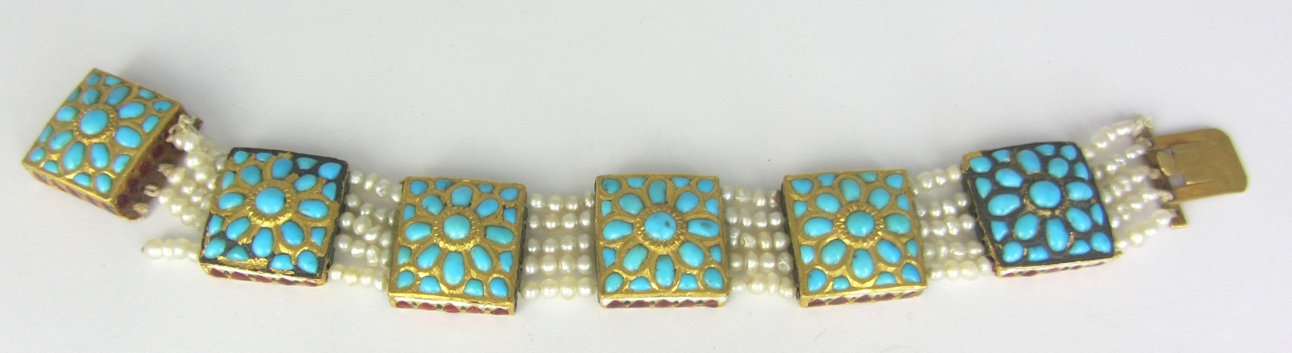 Appraisal: A turquoise seed pearl and enameled bracelet formed as a