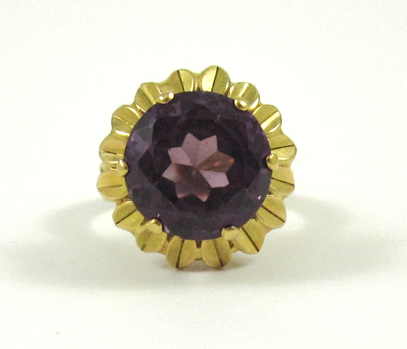 Appraisal: SYNTHETIC ALEXANDRITE AND EIGHTEEN KARAT GOLD RING featuring a round-cut