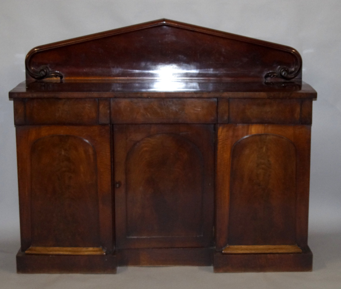 Appraisal: A Victorian mahogany sideboard with a pedimented back three cushion