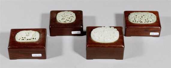 Appraisal: FOUR CARVED JADE MEDALLIONS LATER FITTED ON WOODEN BOXES China