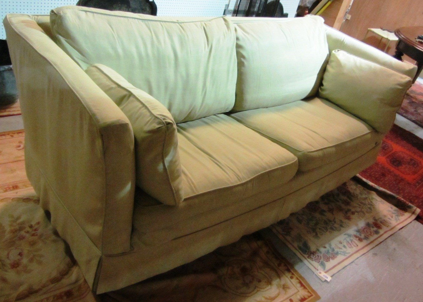 Appraisal: A modern sage green sofa with loose cushions