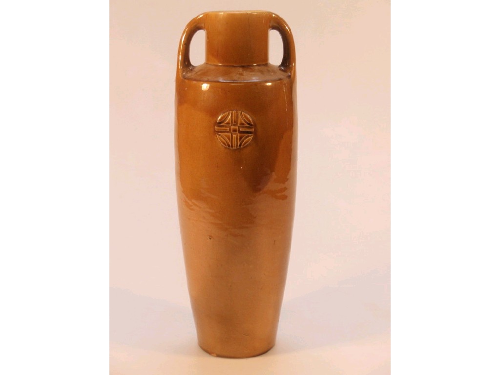 Appraisal: An ochre glazed earthenware two-handled vase of shouldered tapering form