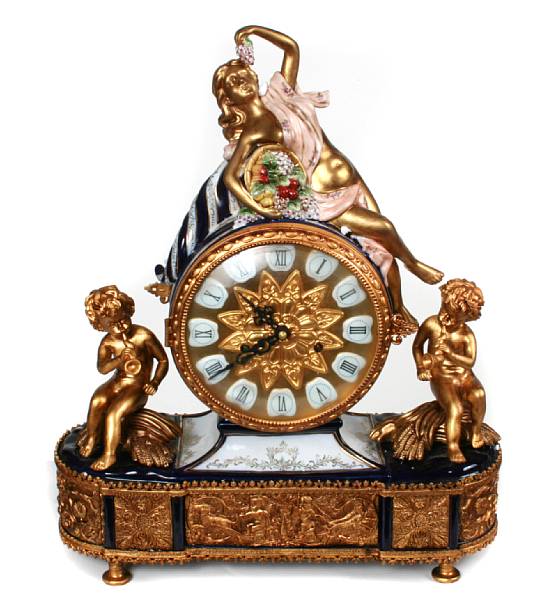 Appraisal: A porcelain and bronze mantle clock height in width in