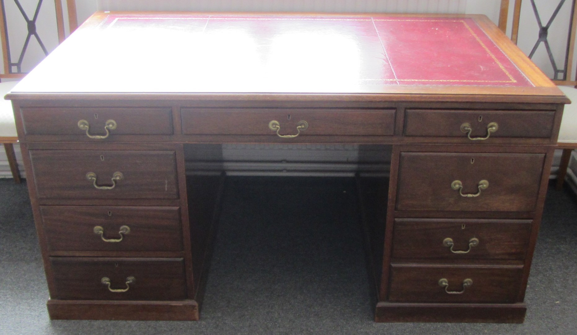 Appraisal: An th century style mahogany pedestal desk with nine drawers