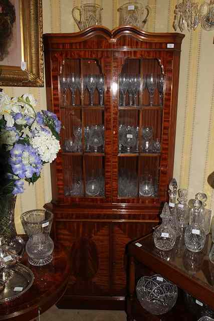 Appraisal: A WALNUT CORNER FLOOR STANDING DISPLAY CABINET with swan neck