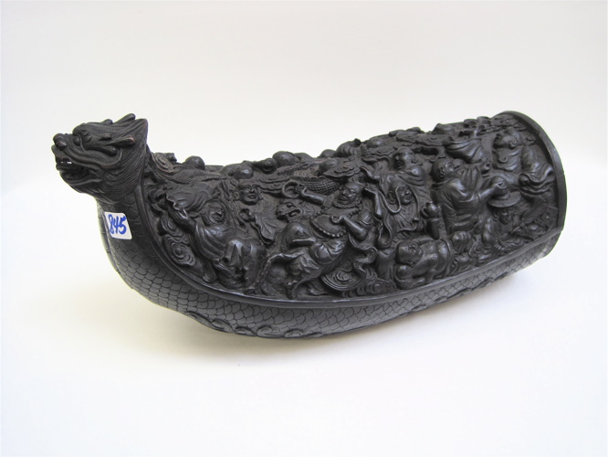 Appraisal: AN ELABORATE CHINESE WOOD CARVING The boat- shaped ebonized vessel