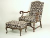 Appraisal: ARM CHAIR AND OTTOMAN - Circa open scroll carved upholstered