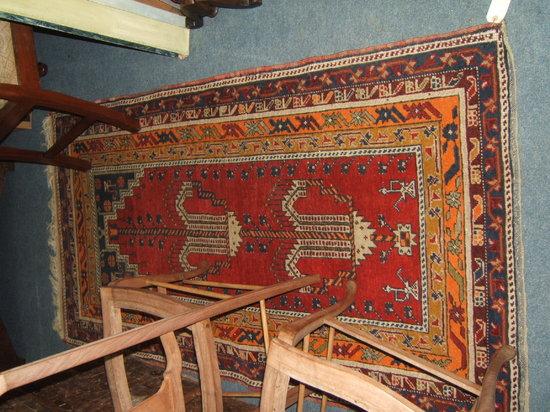 Appraisal: A wine ground Persian prayer mat with stylised design to