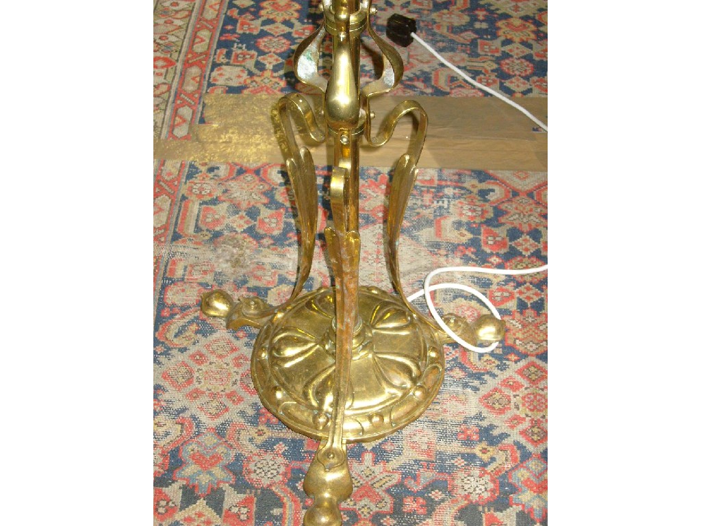 Appraisal: An Art Nouveau style brass standard lamp with relief platform