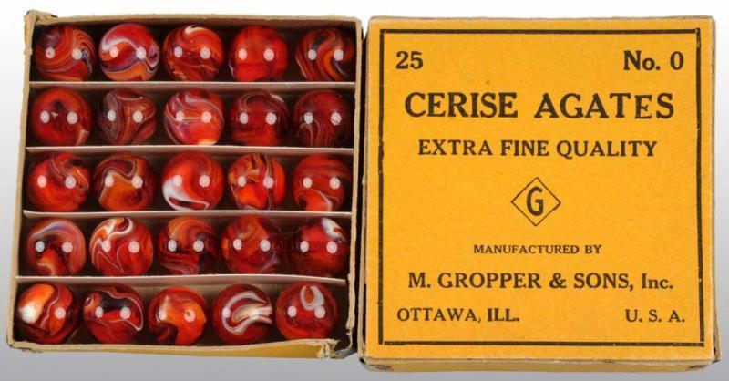 Appraisal: Box of M Grouper Sons Marbles Description Includes red slags