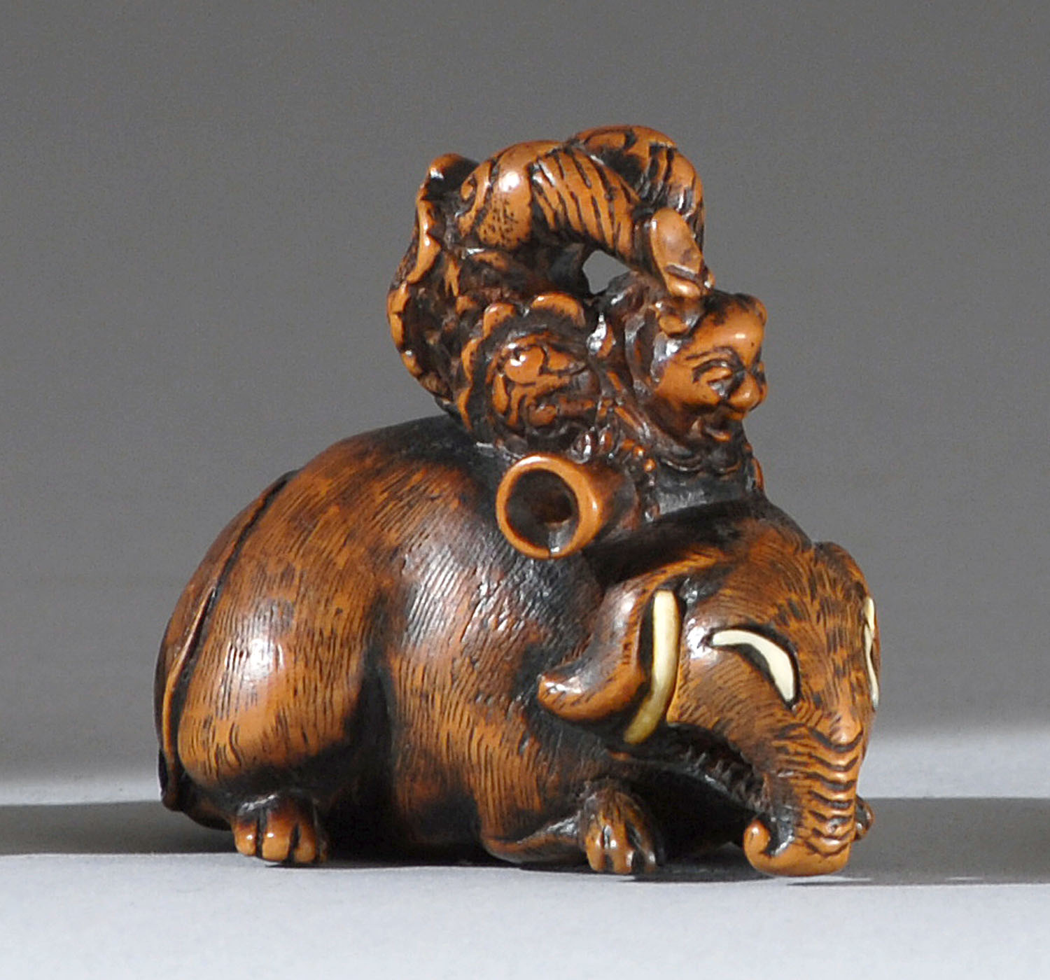 Appraisal: WOOD AND IVORY NETSUKE th CenturyIn the form of an