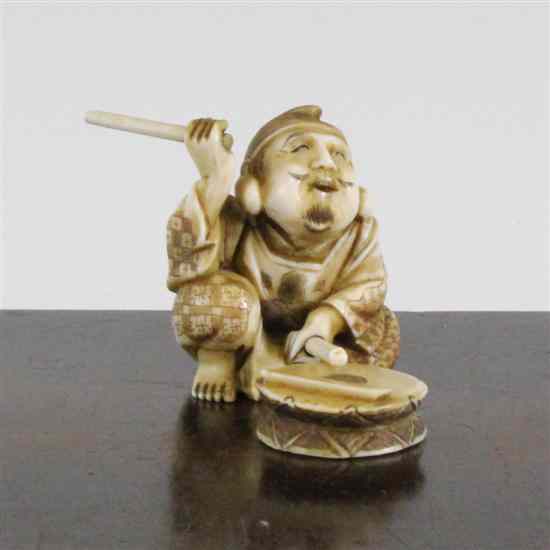 Appraisal: A Japanese ivory seated figure of a drummer early th