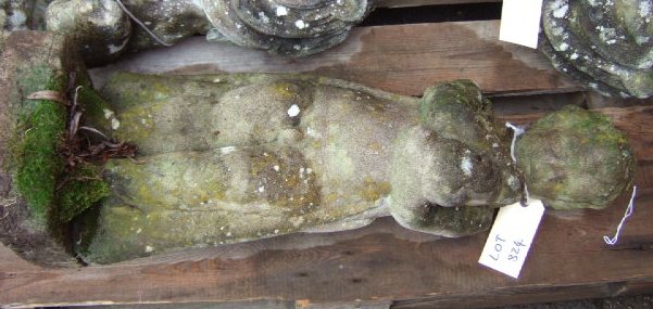 Appraisal: A reconstituted stone figure of a cherub holding a rabbit