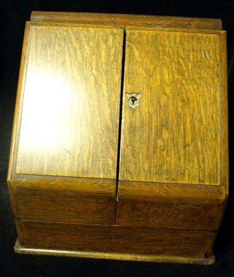 Appraisal: A late Victorian oak stationery rack with perpetual calendar enclosed