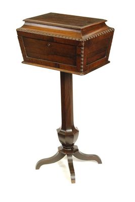 Appraisal: A rosewood sarcophagus shape pedestal sewing box having a plush