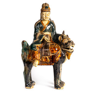 Appraisal: A Chinese Sancai Glazed Pottery Figure of an Immortal Riding