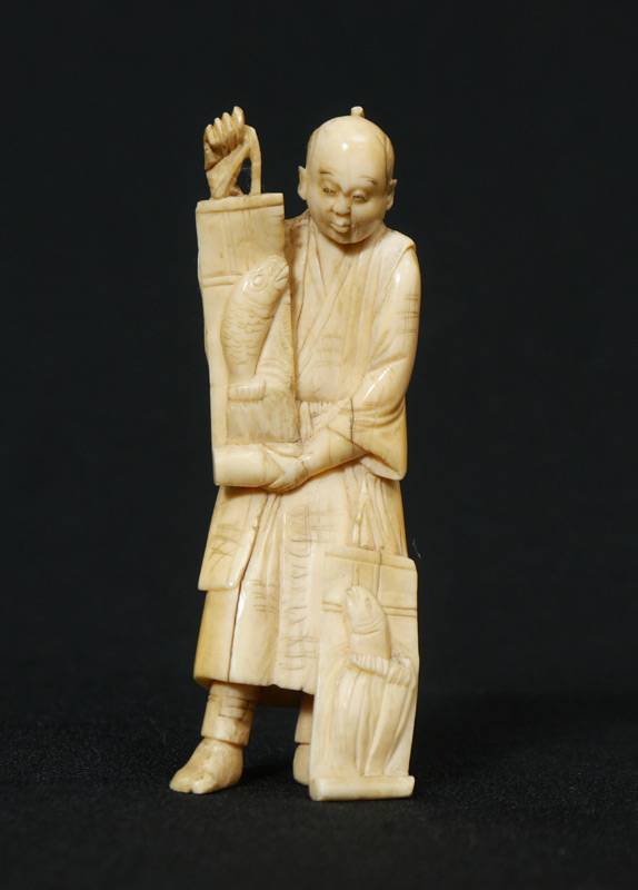 Appraisal: CARVED IVORY FIGURE OF A FISHMONGER Ivory figure of a