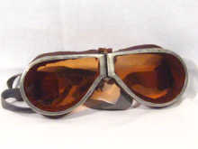 Appraisal: A pair of leather and tinted glass aviator goggles circa