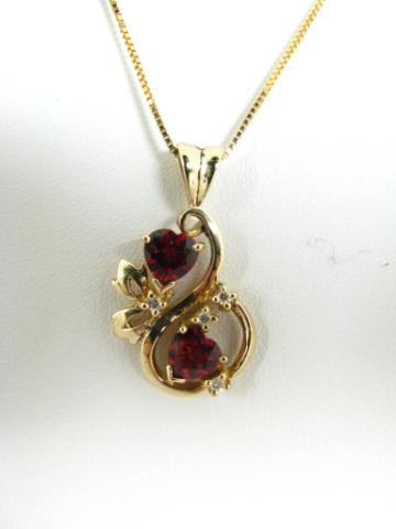 Appraisal: K yellow gold pendant with two heart shaped garnets and