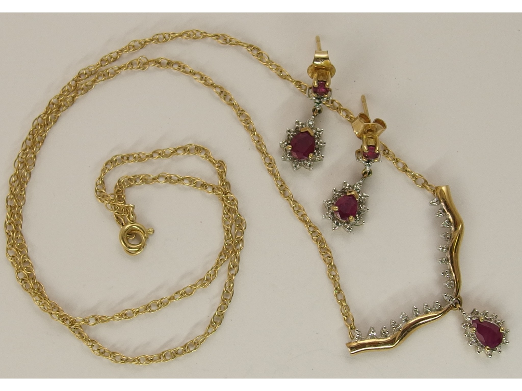 Appraisal: A ct red gemstone and diamond pendant and a pair