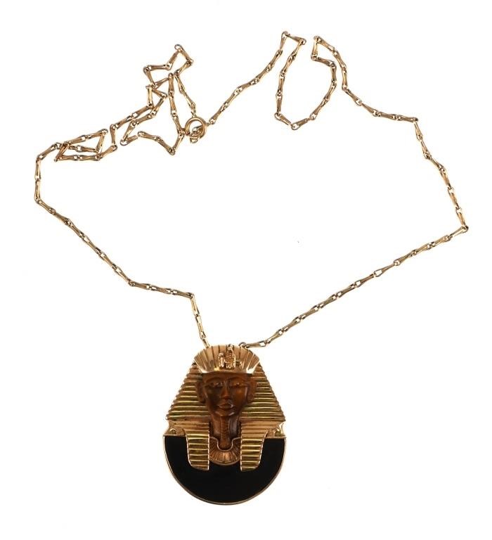 Appraisal: K yellow gold King Tut pendant contains carved Tiger Eye