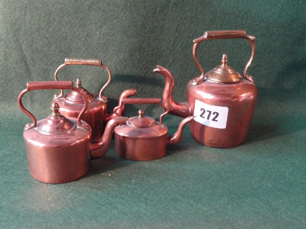 Appraisal: A collection of four various miniature brass kettles with shaped