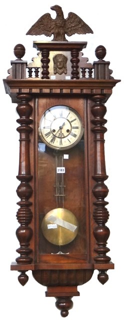 Appraisal: A walnut cased Vienna regulator wall clock with eagle surmount