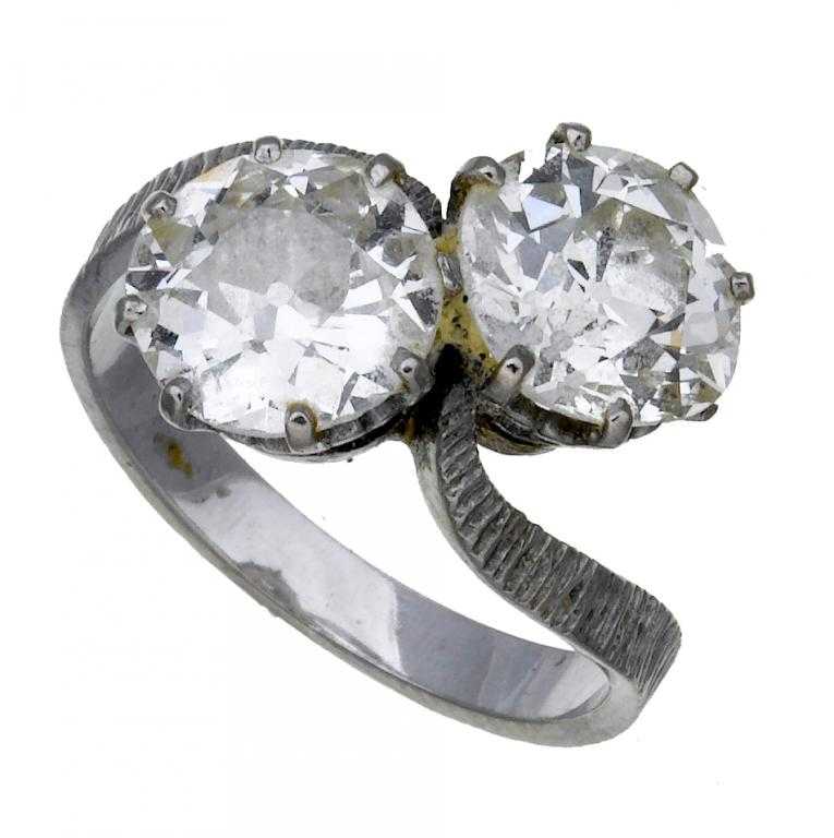 Appraisal: A DIAMOND CROSSOVER RING with two diamonds each weighing approximately