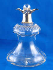 Appraisal: A thistle shaped silver mounted cut glass decanter with four